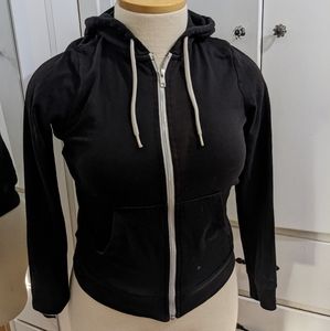 Small black zip up hoodie with white zipper and drawstring